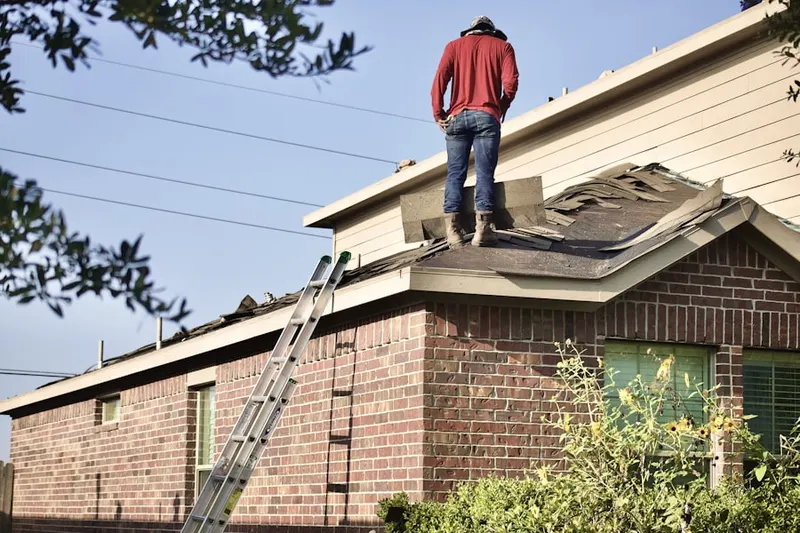 Professional roofer working on a residential roof in Speer